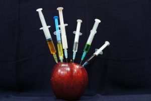 apple fruit with syringes